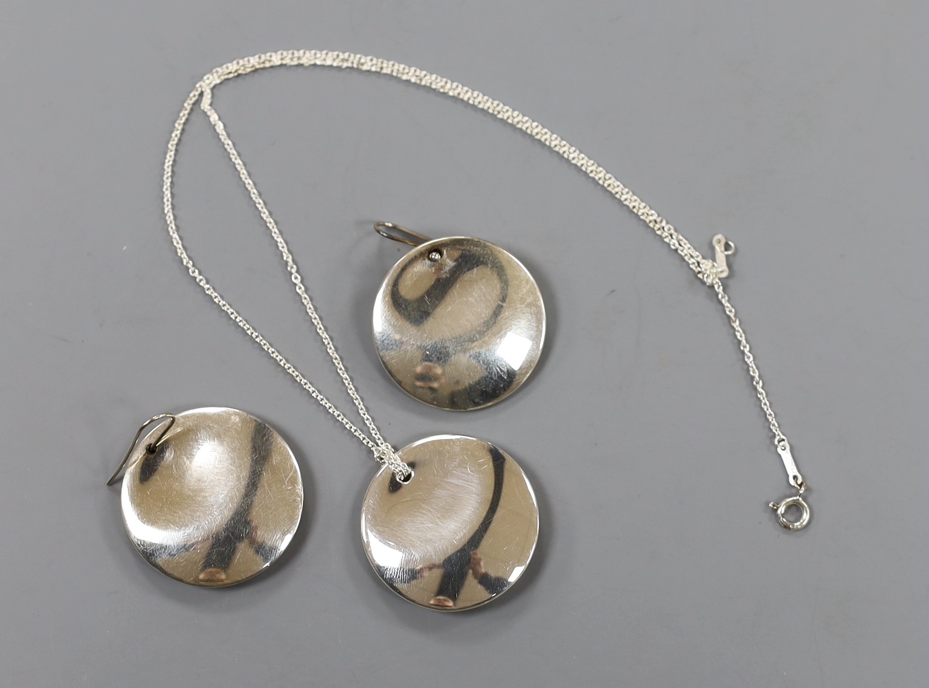 A pair of modern Elsa Peretti for Tiffany & Co sterling disc earrings, 30mm and a matching pendant necklace, both with pouch and box.